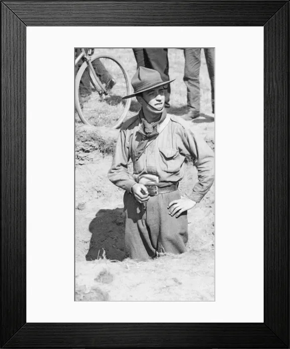 Framed Print : A Boy Scout stands in one of the craters made as a result of one of the three air raids Framed Print : A Boy Scout stands in one of the craters made as a result of one of the three air raids