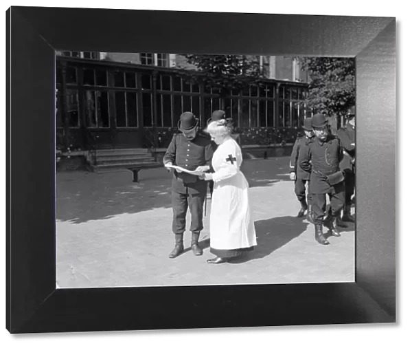 A member of the Belgian Civil Guard seen here in Brussels with Red Cross nurse Circa