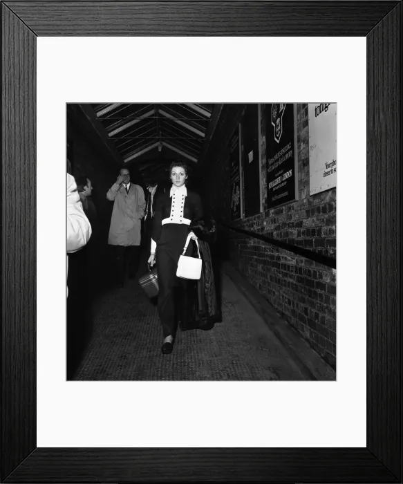 Framed Print : Carolyn Moore walks along the subway at Wilmslow station on her way to meet George Best Framed Print : Carolyn Moore walks along the subway at Wilmslow station on her way to meet George Best