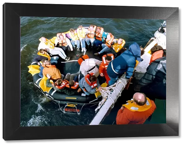 Volunteers clamber into the new life raft during a mock evacuation of the cross Tyne