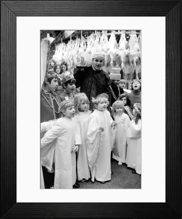 Framed Print : Terry Champion of Hornsey, London, joins the children in carol singing during his work Framed Print : Terry Champion of Hornsey, London, joins the children in carol singing during his work