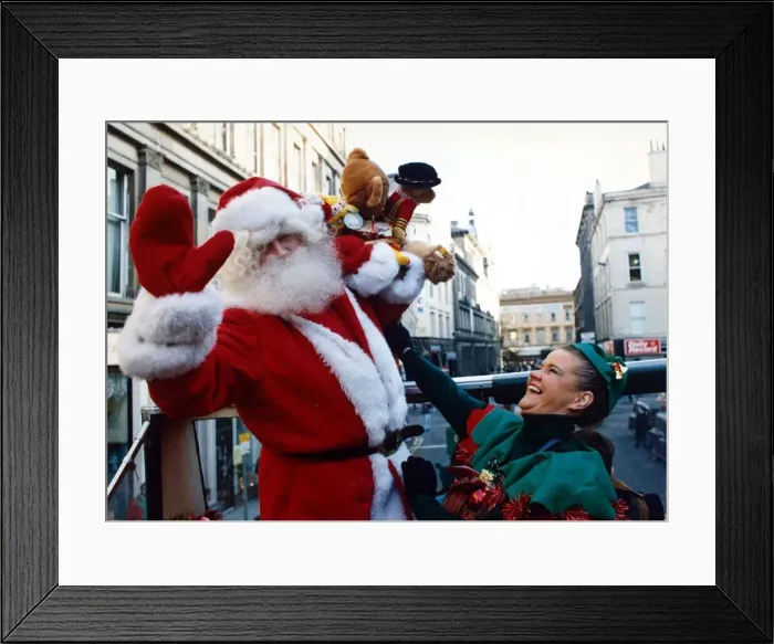 Framed Print : Santa Claus with one of his little elf helpers pictured in Glasgow December 1991 Framed Print : Santa Claus with one of his little elf helpers pictured in Glasgow December 1991