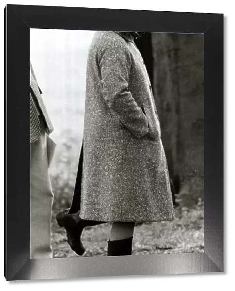 Queen Elizabeth II standing on one leg looking silly wearing wellies June 1980