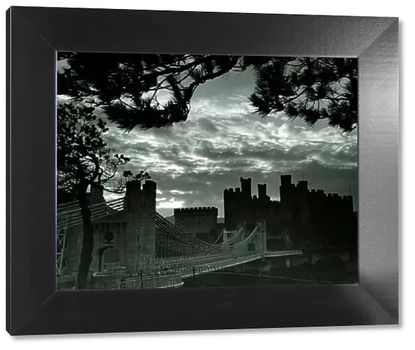 Night hides the scars of seven centuries, and in this picture Conway castle might still