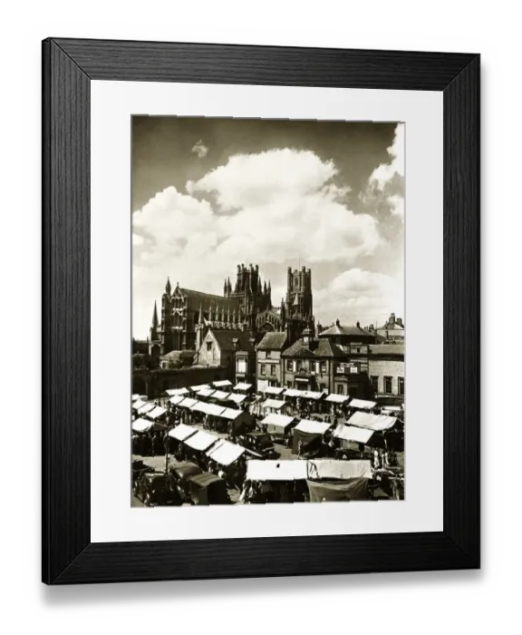 Framed Print : Ely Cathedral Cambridgeshire over looking the town square on a market day Framed Print : Ely Cathedral Cambridgeshire over looking the town square on a market day