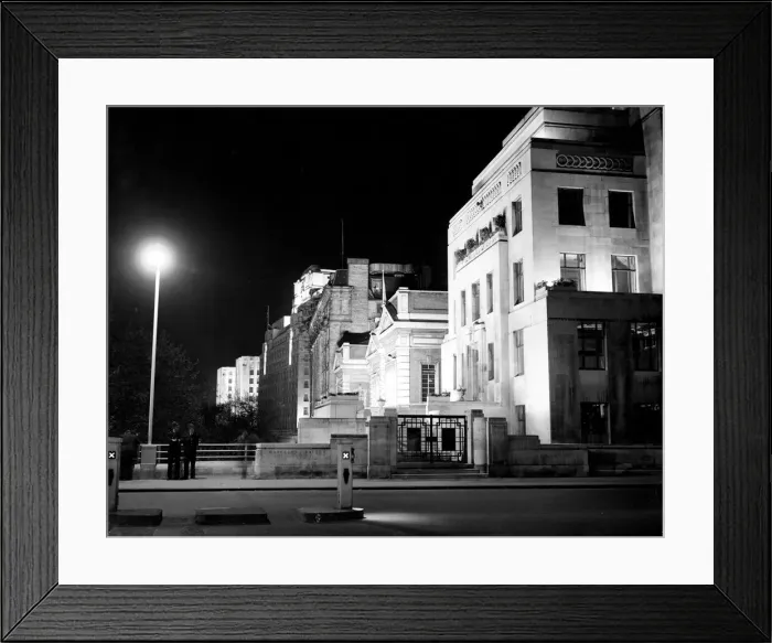 Framed Print : London by night two policemen stand on a bridge on the Embankment with Shellmex Framed Print : London by night two policemen stand on a bridge on the Embankment with Shellmex