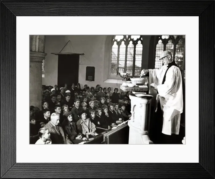 Framed Print : Unusual - A vicar prepares his christmas pudding at a service in church