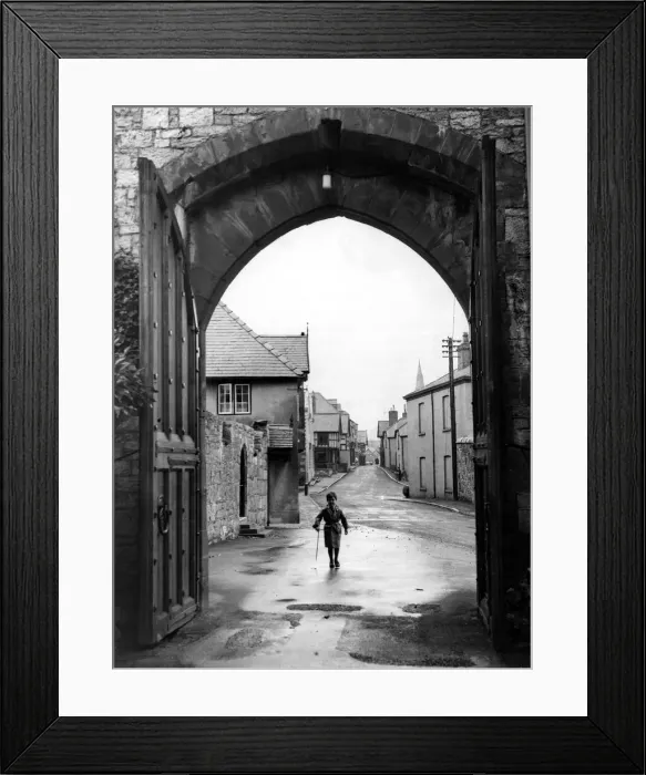 Framed Print : A small boy walks through the archway at the entrance of Ruthin Castle Denbighshire Framed Print : A small boy walks through the archway at the entrance of Ruthin Castle Denbighshire