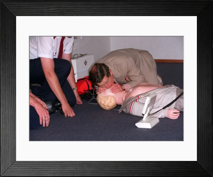 Framed Print : Prince Charles getting up close and personal with a rescussitation dummy Framed Print : Prince Charles getting up close and personal with a rescussitation dummy