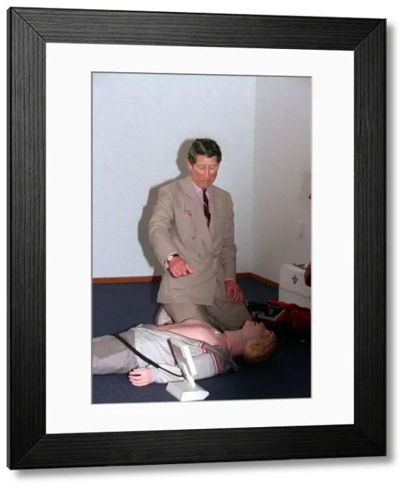 Framed Print : Prince Charles getting up close and personal with a rescussitation dummy Framed Print : Prince Charles getting up close and personal with a rescussitation dummy