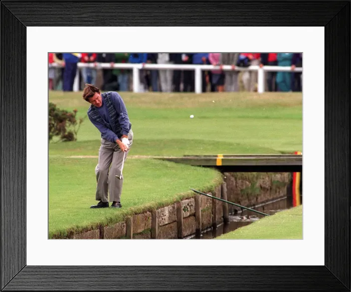 Framed Print : Nick Faldo plays over the Swilken burn at the 1st after putting his ball in the water in Framed Print : Nick Faldo plays over the Swilken burn at the 1st after putting his ball in the water in