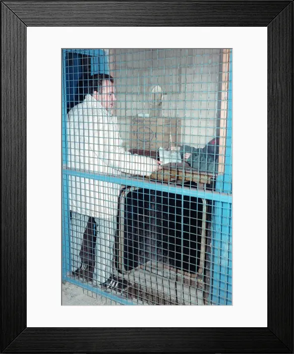 Framed Print : A football fan hands in his ticket to be checked as he mnakes his way through Framed Print : A football fan hands in his ticket to be checked as he mnakes his way through