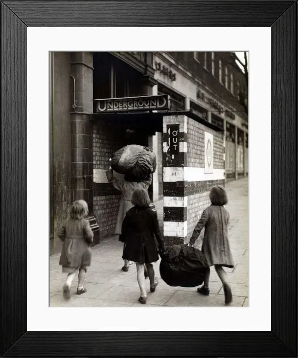 Framed Print : Children carrying bundles of laundry run towards the London Underground to take cover Framed Print : Children carrying bundles of laundry run towards the London Underground to take cover