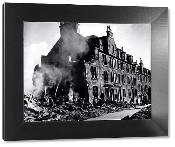 World War Two Firemen damp down a fire at a Scottish tenement block after a German air
