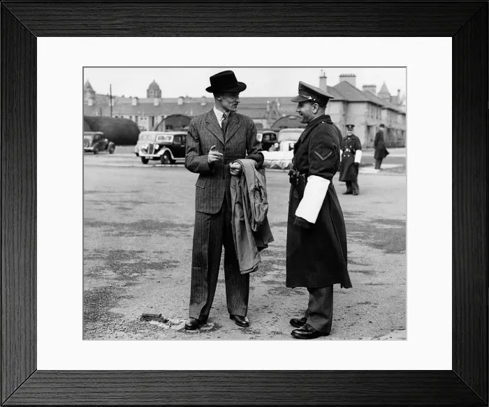 Framed Print : World War Two Newly discharged soldier in his demob clothes saying goodbye to a Framed Print : World War Two Newly discharged soldier in his demob clothes saying goodbye to a