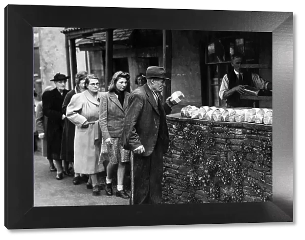 Wartime food rationing - people queuing up for their shopping - bread rationing