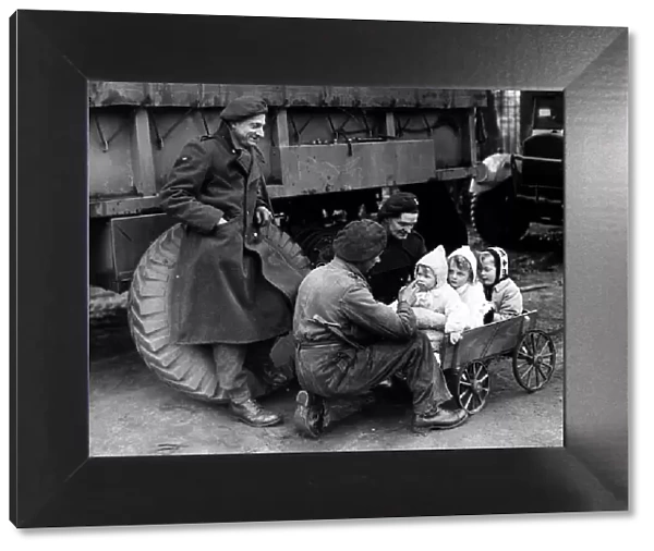 War: Invasion of France February 1945 British troops with German children
