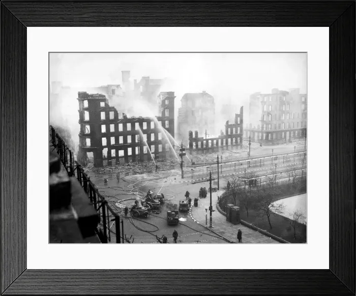 Framed Print : Firemen play water from their hoses on to the smouldering remains of offices in Framed Print : Firemen play water from their hoses on to the smouldering remains of offices in