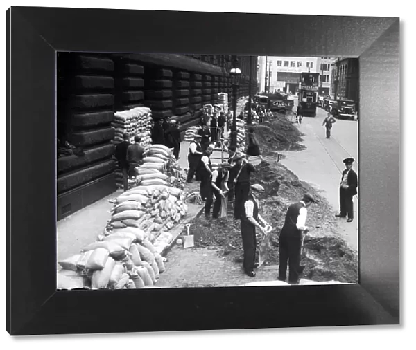 WW2 September 1939 Civilians filling sandbags - lining the streets in a team effort