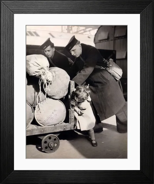 Framed Print : Little Jean Butcher age 3 gives two sailors a hand to push the barrow containing their Framed Print : Little Jean Butcher age 3 gives two sailors a hand to push the barrow containing their