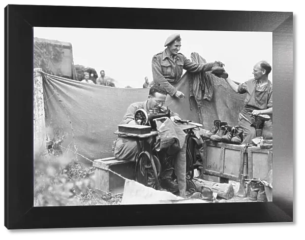 WW2 August 1944 Front line tailor and cobbler. Private Peter Barnes collects his
