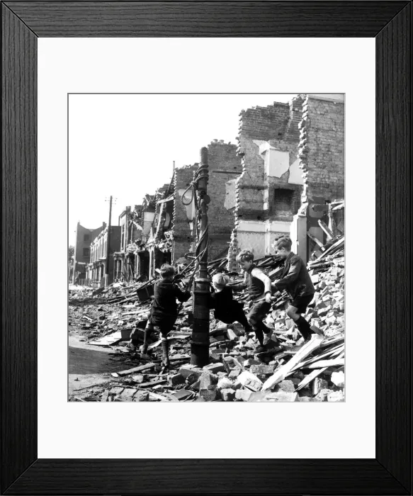 Framed Print : Children playing on a makeshift swing amidst rubble during the blitz attack of the German Framed Print : Children playing on a makeshift swing amidst rubble during the blitz attack of the German