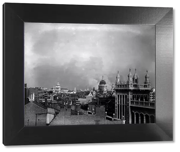 Smoke rises from behind the dome of St Pauls Cathedral after the first daylight bombing