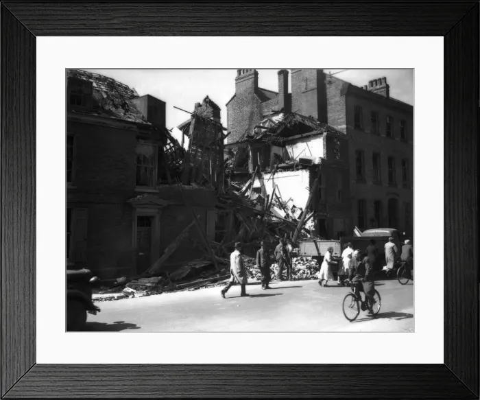 Framed Print : WW2 York Air Raid Bomb Damage Civilians walk pass bomb damaged housing in York as