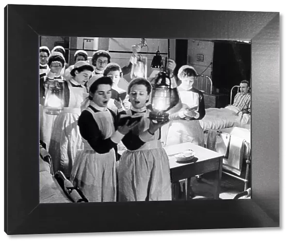 Scene at Westminister Hospital on Christmas Eve - 1940 Nurses walk through wards