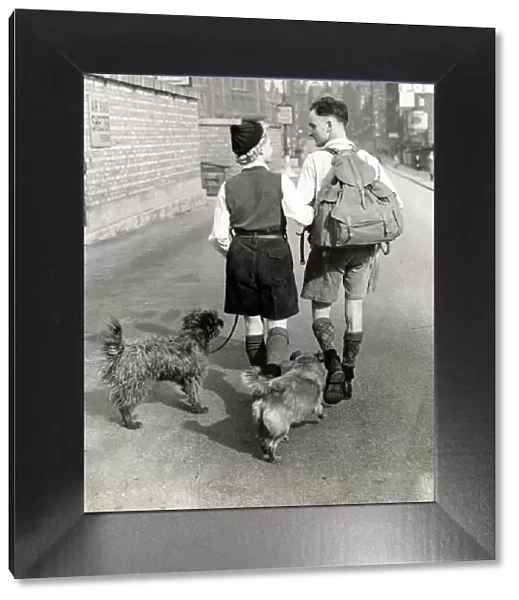 A young couple hiking with their dogs down a Manchester