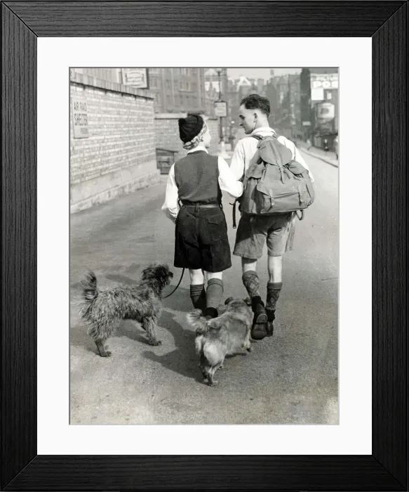 Framed Print : A young couple hiking with their dogs down a Manchester Framed Print : A young couple hiking with their dogs down a Manchester