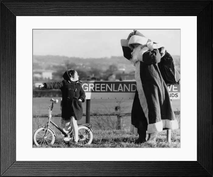 Framed Print : That way, Santa, says toddler Laura Tyrell, aged 4, to Father Christmas after he got