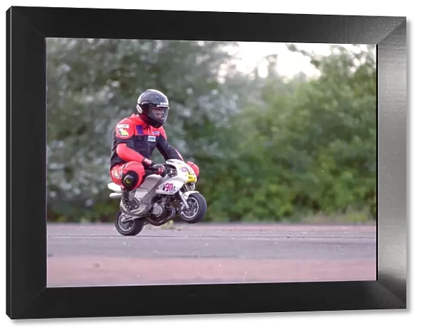 A rider on his mini-moto racing motorcycle