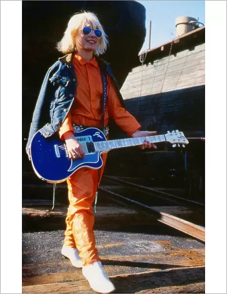 Debbie Harry January 1980 Holding guitar sun glasses orange suit blue denim jacket