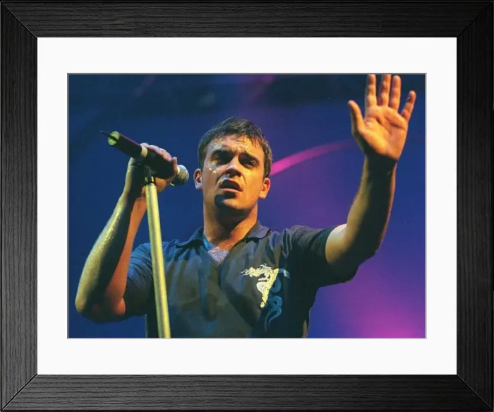 Framed Print : Robbie Williams waves to the audience at his concert in Aberdeen. February 1999