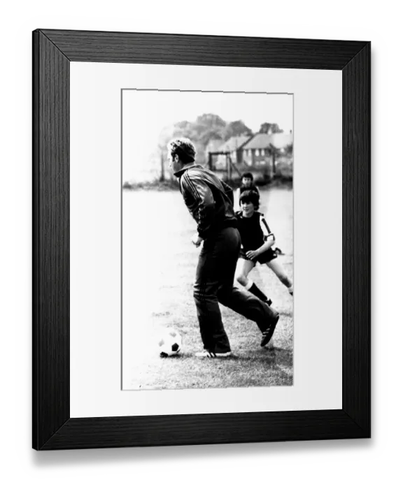 Framed Print : Former England footballer Bobby Moore coaches children at the Coral sponsored Bobby Moore Framed Print : Former England footballer Bobby Moore coaches children at the Coral sponsored Bobby Moore