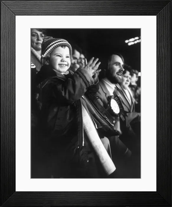 Framed Print : Three year old Terry Morris watching Manchester United with his dad in the grandstand Framed Print : Three year old Terry Morris watching Manchester United with his dad in the grandstand