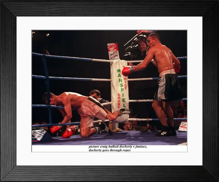 Framed Print : Daniel Jiminez of Puerto Rico punches Drew Docherty of Scotland through the ropes Framed Print : Daniel Jiminez of Puerto Rico punches Drew Docherty of Scotland through the ropes