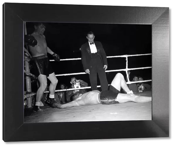 Tommy Farr looks down on his opponent Jan Klein when they met 27  /  9  /  1950