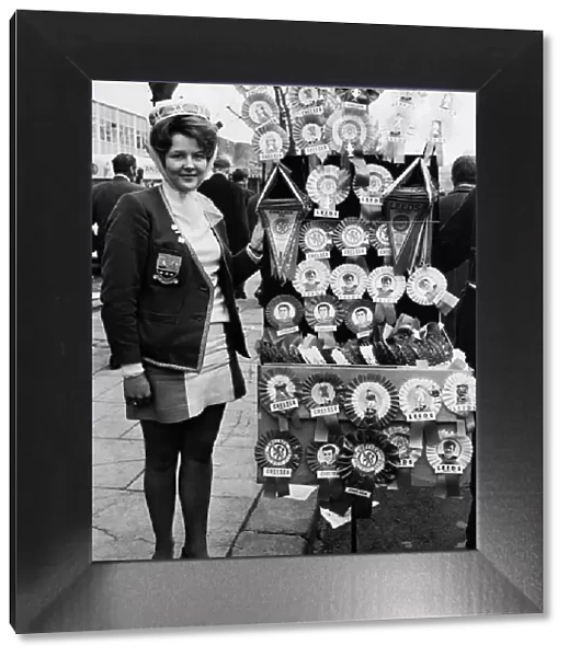 Leeds United supporter Mrs Barbra Pewte seen here standing beside a rosette stall outside