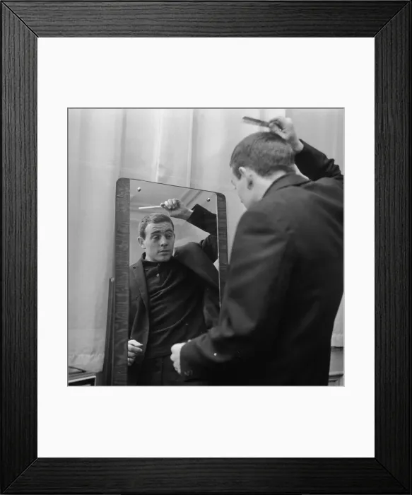 Framed Print : Liverpool player Ian St John looks in the mirror to comb his hair as he gets ready for Framed Print : Liverpool player Ian St John looks in the mirror to comb his hair as he gets ready for
