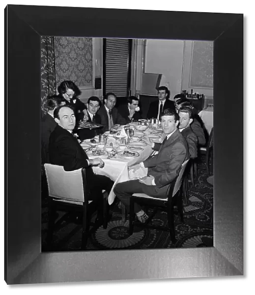 Liverpool players seated around a table for dinner at their London hotel before their FA