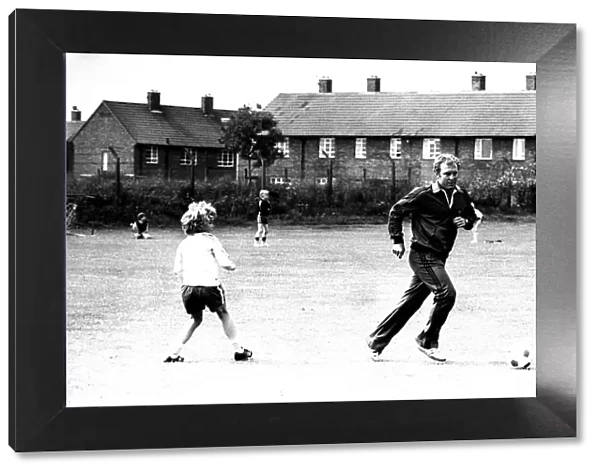 Former England footballer Bobby Moore coaches children at the Coral sponsored Bobby Moore
