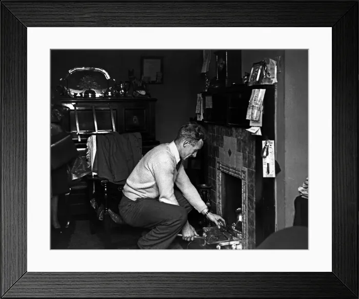 Framed Print : Footballer Billy Wright Wolves and England captain seen here putting coal on the fire Framed Print : Footballer Billy Wright Wolves and England captain seen here putting coal on the fire