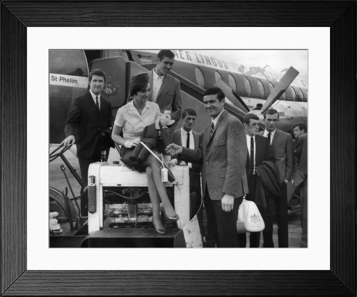 Framed Print : Air Hostess Paddy Clinch of Dublin presents Liverpool captain Ron Yeats with a leprechaun Framed Print : Air Hostess Paddy Clinch of Dublin presents Liverpool captain Ron Yeats with a leprechaun