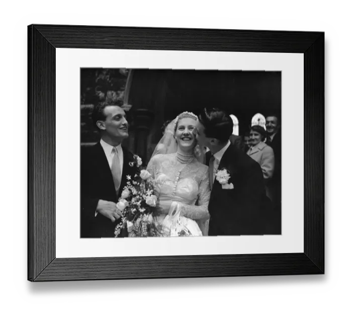 Framed Print : John Haynes, Fulham and England footballer (Right), kisses the bride the fomer Miss