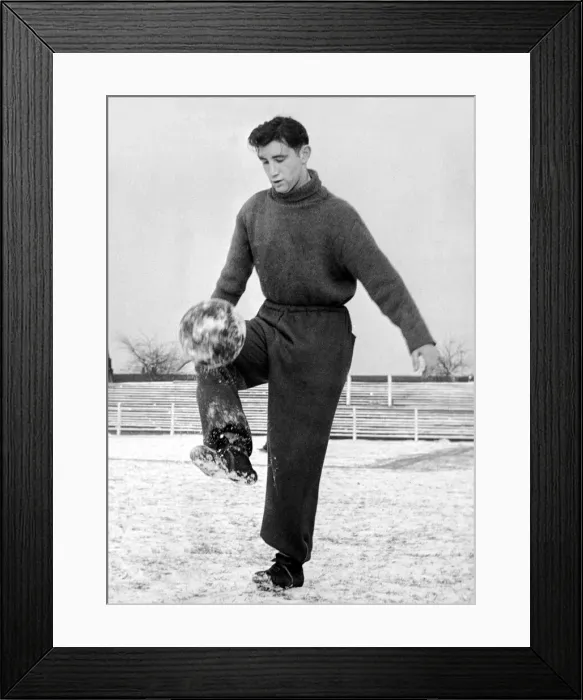 Framed Print : Carlisle United footballer Geoff Twentyman practices his ball control skills in the snow