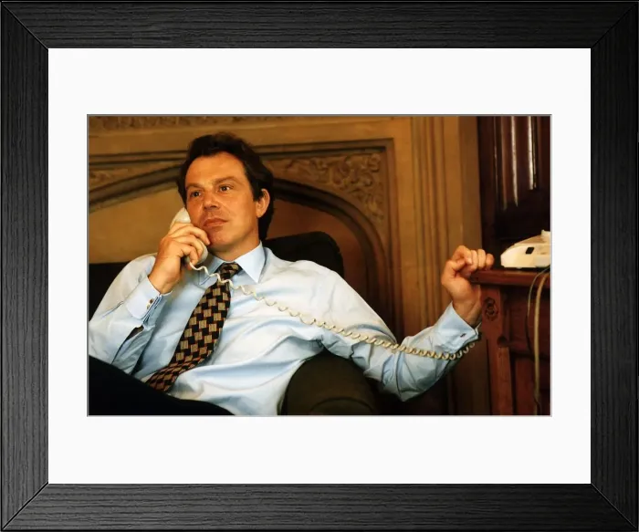 Framed Print : Tony Blair sitting on the sofa holding a telephone handset to his ear Framed Print : Tony Blair sitting on the sofa holding a telephone handset to his ear