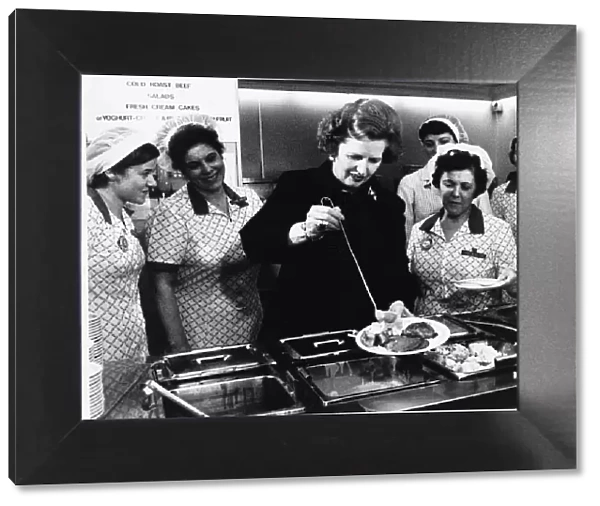 Margaret Thatcher Prime Minister takes her turn serving behind a staff canteen counter