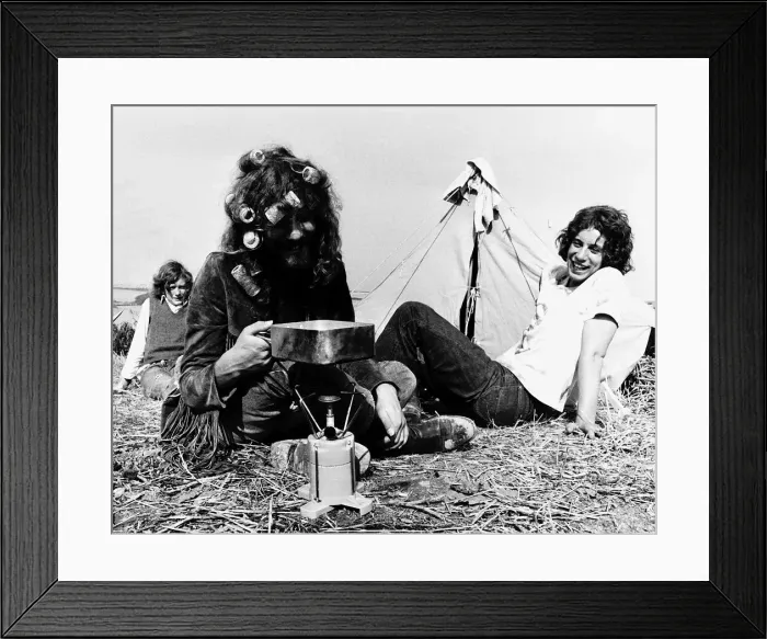 Framed Print : Hippies on Isle of Wight for pop festival cooking on camping stove in front of tent